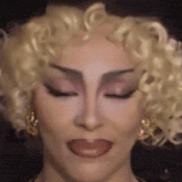 a close up of a woman 's face with her eyes closed and her tongue out
