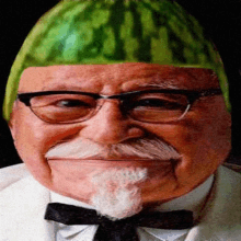 a man wearing glasses and a bow tie has a watermelon on his head