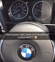 a picture of a bmw steering wheel with the words weird green light came on should i be concerned