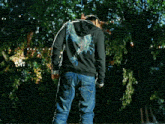 a man wearing a superman t-shirt and a black hoodie