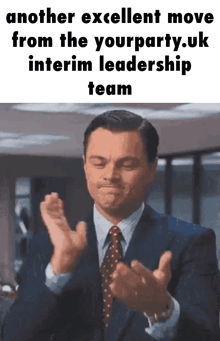 a man in a suit and tie is clapping his hands with the words another excellent move from the yourparty.uk interim leadership team below him