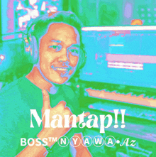 a man wearing headphones giving a thumbs up in front of a keyboard with the words mantap written below him