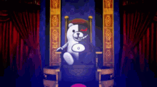 a black and white teddy bear is sitting on a throne in a room with red curtains .