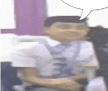 a blurry picture of a man with a speech bubble above him