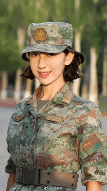 a woman in a military uniform has a star on her cap