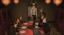 a group of people sitting around a table with chinese writing on a board