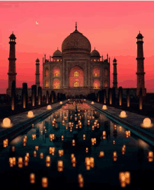 the taj mahal is lit up at sunset with candles in the water