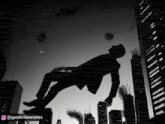 a man in a suit is falling through the air in a city