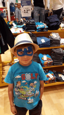 a young boy wearing a blue shirt that says golf