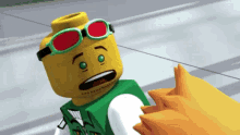 a lego man wearing sunglasses and a green vest looks surprised