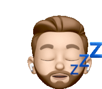 a man with a beard and ear buds is sleeping with the letters zzz behind him