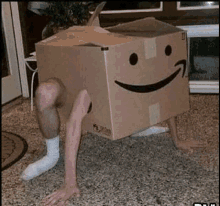 a person is standing in a cardboard box with their legs sticking out of it and a smiley face on it .