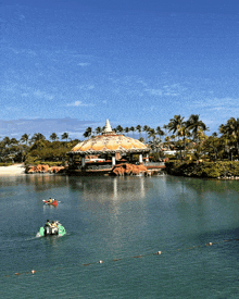 a group of people in kayaks are floating in the water near a carousel