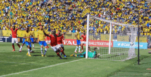 soccer players on a field with a sign that says balltogether in the background