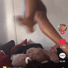 a woman 's legs are shown in a tiktok video with a teddy bear in the foreground