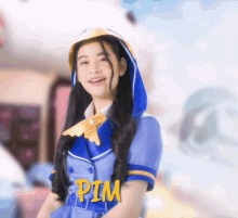 a girl wearing a blue outfit with the word pim on the waist