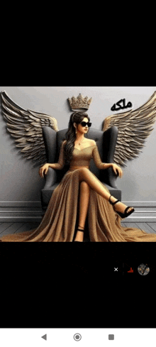 a woman in a long dress is sitting on a chair with wings and a crown on her head