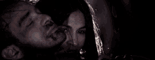 a man and a woman kissing in the dark