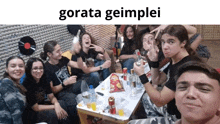 a group of people sitting around a table with a caption that says gorata geumplei