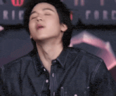 a close up of a person 's face with their eyes closed and their mouth open .