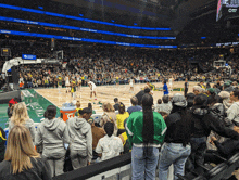 a crowd of people watching a basketball game with a gatorade cooler in the stands