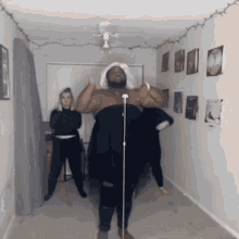 a group of people are dancing in a room with a man wearing a turban