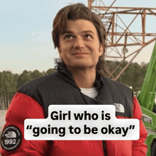 a man is wearing a red north face jacket