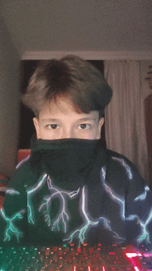 a boy wearing a hoodie with lightning on it