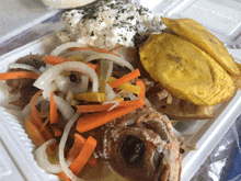 a plastic container filled with fried fish vegetables and a plantain slice