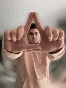 a man making a triangle with his hands