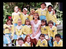 a group of children are posing for a picture with their teacher who is wearing a headband that says " mexico "