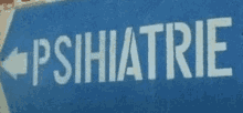 a blue sign that says ' psihiatrie ' on it