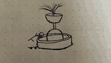 a drawing of a fountain with a plant in it is on a piece of paper