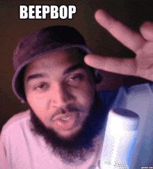 a man with a beard is wearing a hat and making a peace sign with the words beep bop above him