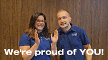 a man and a woman are standing next to each other with the words " we 're proud of you " behind them