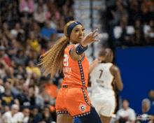 a female basketball player wearing a jersey with the number 21 on it