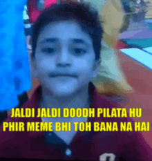 a young boy in a red shirt with a caption that says jaldi jaldi doodh pilata hu