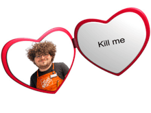 a man in a home depot apron is behind a heart shaped mirror that says " kill me "
