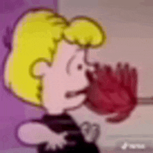 a close up of a cartoon character holding a red object .