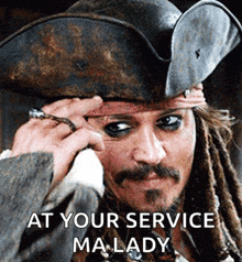 a man with dreadlocks is wearing a pirate hat with the words at your service ma lady below him .