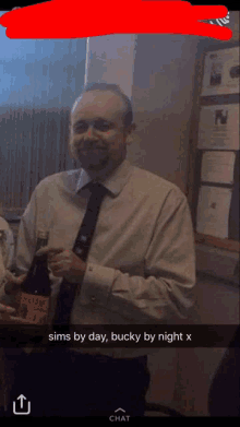 a man in a suit and tie is holding a bottle of wine