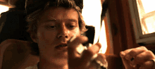 a close up of a man lighting a lighter with a lighter .