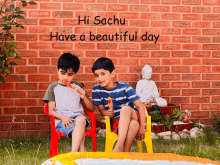 two young boys eating popsicles in front of a brick wall with hi sachu have a beautiful day