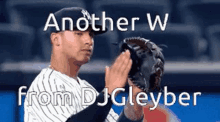 a baseball player is holding a catcher 's mitt in front of a sign that says another w from dj gleyber .