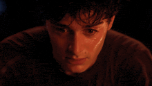 a man with sweat on his face looks at the camera