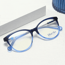 a pair of blue sky glasses are sitting on a white surface