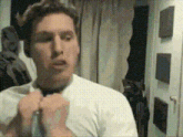 a man wearing a white shirt and tie is making a funny face