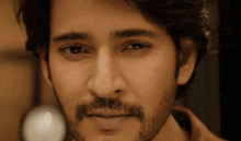 a close up of a man with a beard and mustache