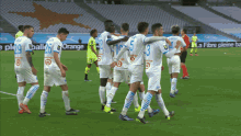 a group of soccer players are standing on a field with a sign in the background that says la fibre pleine ba