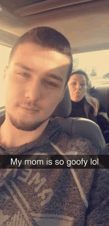 a man is taking a selfie with his mom in the back seat